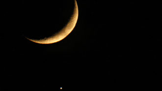 This photo taken on December 1, 2008 in Nice, southern France shows the moon's shadow falling on the Venus planet. The lunar cover-up is similar to a solar eclipse except that it is Venus being hidden instead of the Sun.   AFP PHOTO VALERY HACHE